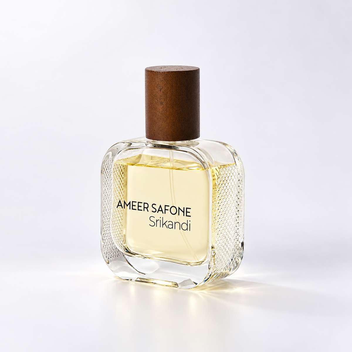 Ameer Safone Srikandi perfume bottle with a clear textured glass body, pale yellow liquid, a dark brown wooden cap, and black text on the front, set against a clean white background.